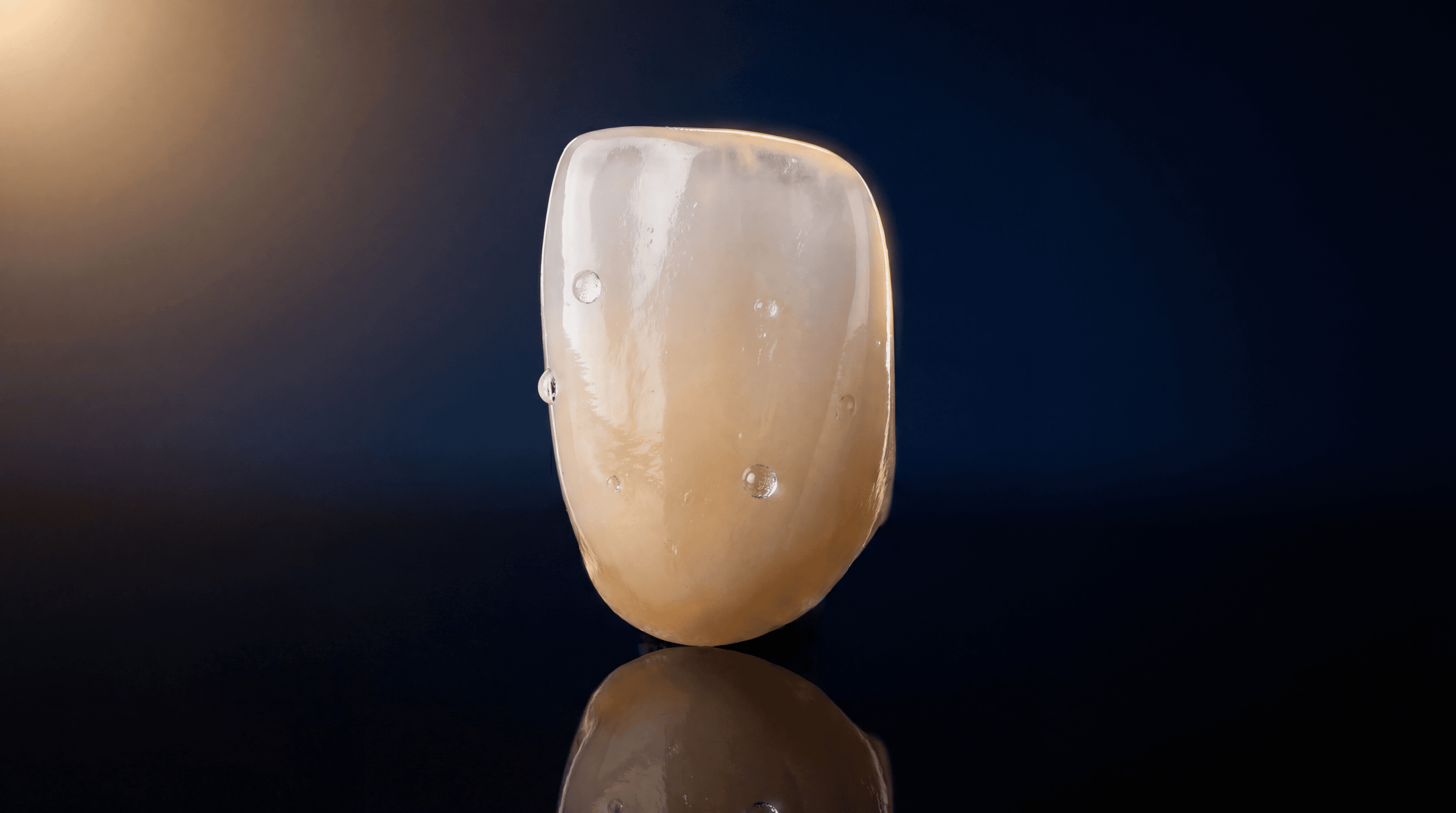 Lithium disilicate anterior crown with natural translucency and opalescence on pitch-black background