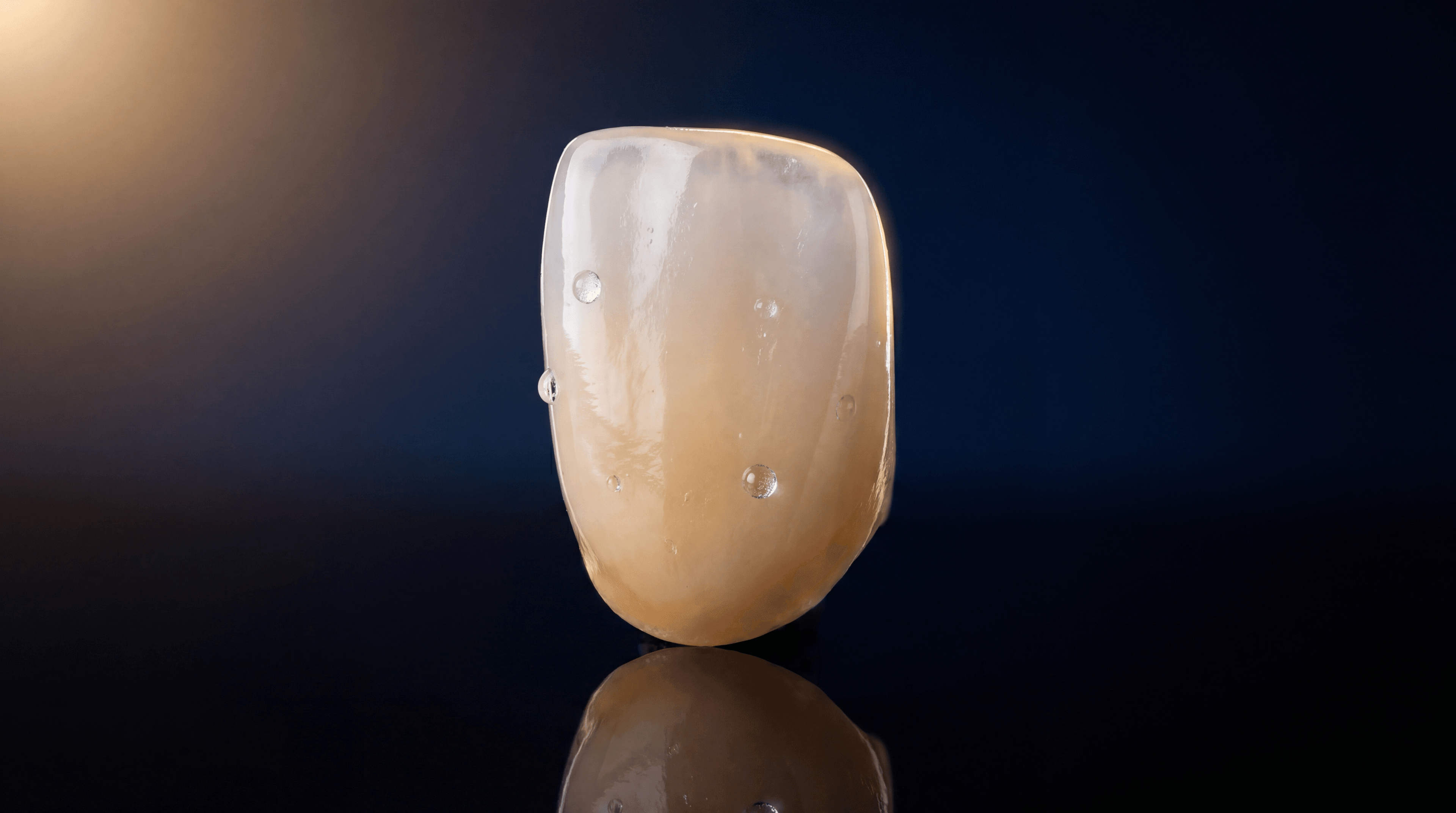 Lithium disilicate anterior crown with natural translucency and opalescence on pitch-black background